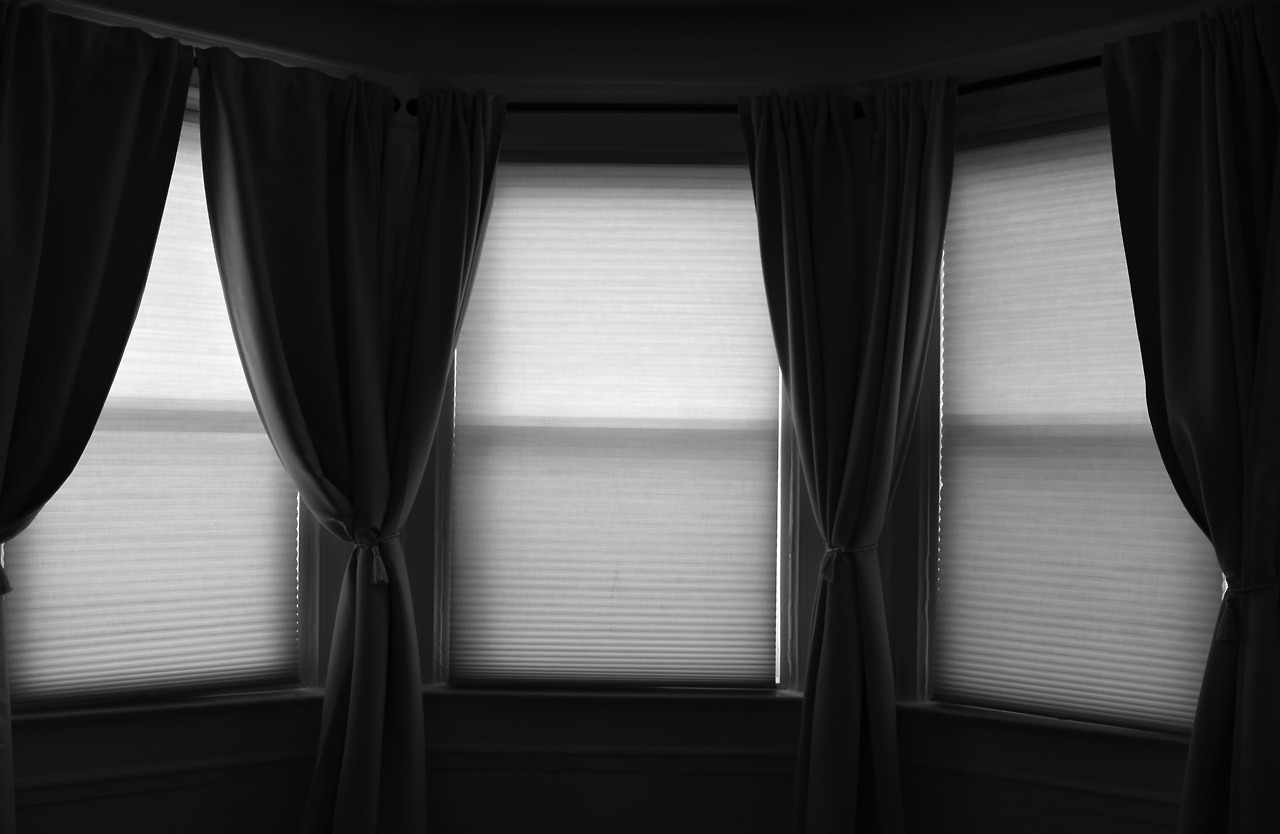 A black and white photograph of three windows.